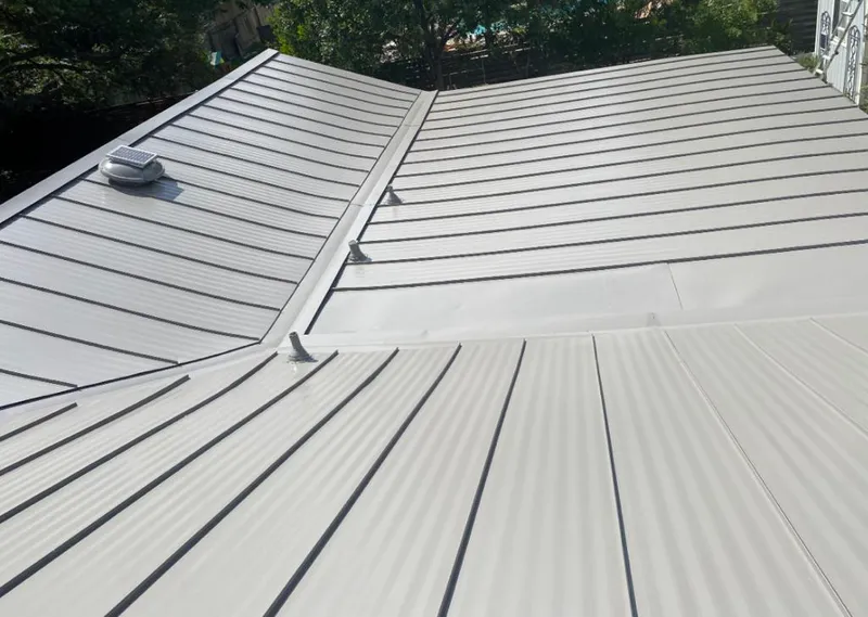 Solar attic fan installed on a metal roof for Roof Ventilation in Gonzales